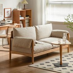 a living room scene with focus on the couch and coffee table in the foreground