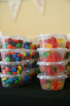 plastic containers filled with gummy bears on top of a table