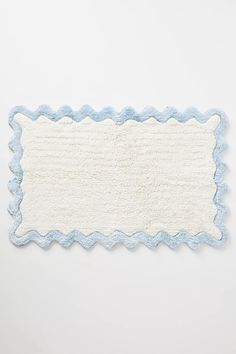 a white and blue place mat with scalloped edges