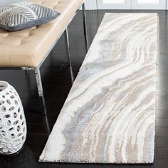 a white rug sitting on top of a wooden floor