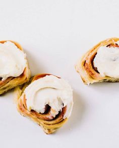 three pastries with white frosting on them