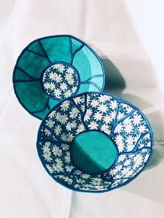 three blue and white bowls sitting on top of a table