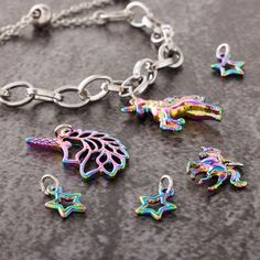 Find the Oil Slick Unicorn Charm Set by Bead Landing™ at Michaels. This fun charm set from Bead Landing will add a playful touch of magic to your accessory creations. Featuring a mix of unicorns and stars with a shimmery oil slick finish, these charms will make a great addition to a chain bracelet or necklace or use to make cute mismatched pairs of dangly earrings. This fun charm set from Bead Landing will add a playful touch of magic to your accessory creations. Featuring a mix of unicorns and Multicolor Removable Charms For Jewelry Making, Playful Multicolor Jewelry With Star Charm, Rainbow Heart Charm Jewelry For Valentine's Day, Cheap Multicolor Nickel-free Charm Necklace, Playful Rainbow Charm Necklaces For Gifts, Nickel-free Multicolor Metal Charm Bracelet, Unicorn Charm Bracelet, Bead Landing, Unicorn Charm