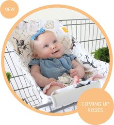 a baby sitting in a shopping cart with the words coming up roses on it's side