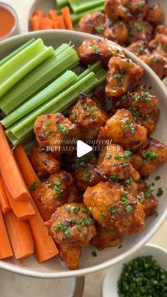 chicken wings with carrots and celery on a plate