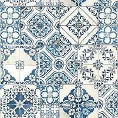 a blue and white tile wall with different designs