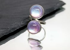 Who doesn't need a little sparkle in their life? Artisan Mimi created these resin beauties for this adjustable stainless steel ring. These XL glitter in resin cabochons measure 12mm each. Note: color was very difficult to photograph and seems to change in different kind of lighting (natural to inside lights). They have stronger pink hues than blue. Use this shop's search feature for available matching pieces. FREE SHIPPING, always. VARIATIONS OF COLOR can occur when comparing the actual product Adjustable Silver Glitter Jewelry, Adjustable Iridescent Rings, Glitter In Resin, Resin Galaxy, Glitter Ring, Resin Glitter, Stainless Steel Ring, Multi Stone Ring, Stainless Steel Rings