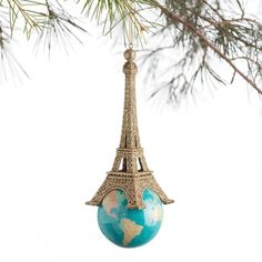 the eiffel tower ornament is hanging from a tree