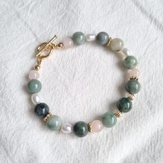 Length: 18cm Made using 8mm burma jade gemstones, freshwater pearls and 14k gold-plated beads. Pearl Bracelet With Jade Round Beads, Pearl Bracelet With Jade And Natural Stones, Jade Pearl Bracelet With Natural Stones, 2022 Jewelry, Jade Bracelet, Jewelry Diy, Pearl Jewelry, Arm Band, Freshwater Pearls