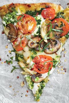 a slice of pizza with tomatoes, mushrooms and other toppings on top of it