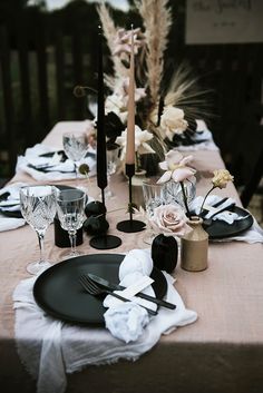 the table is set with black and white place settings