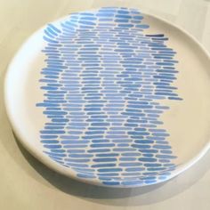 a blue and white plate sitting on top of a table