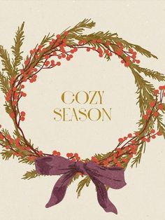 a wreath with red berries and purple bow on it that says cozy season in gold lettering