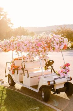 a white golf cart with flowers on the back