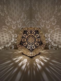 an intricately designed lamp casts a shadow on the wall