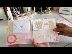 someone is holding an open card with the words happy written on it, and there are other cards in front of them