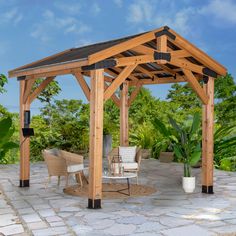 a wooden gazebo sitting on top of a stone patio