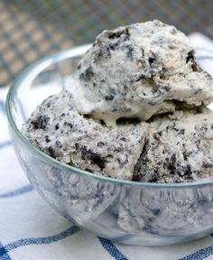 a bowl filled with ice cream on top of a blue and white checkered table cloth