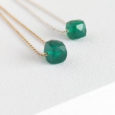 The Emerald Green Onyx Cube Necklace is a stunning piece of jewellery that showcases a faceted emerald green cube on a delicate cable chain. This minimalist design is available in both sterling silver and gold-filled metals, allowing you to choose the perfect option to suit your style. You can also select between a 6mm or an 8mm stone size for a personalized touch. Wearing Green Onyx is believed to attract positive energy and boost confidence. It is also commonly used as a substitute for emerald Attract Positive Energy, Cube Necklace, Boost Confidence, Basic Jewelry, May Birthstone, Wear Green, Birthstone Gifts, Green Onyx, Silver Pieces