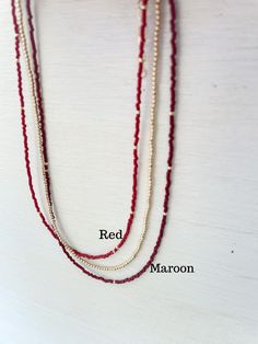 Red seed bead necklace. Perfect for Ole Miss or Georgia game day! Duracoat seed beads mixed in with a few 14k gold filled beads. These seed beads have an extra-durable coating called Duracoat®. This clear coating improves the resiliency of beads that may receive extra wear. Each necklace is handmade and the amount of gold beads will vary Choose length. If you need a different size just send us an email! Materials made in the USA then assembled in our MS studio. Georgia Game Day, M&m Game, Mississippi State, Ole Miss, Creating Jewelry, Seed Bead Necklace, Pure Gold, Gold Filled Jewelry, Gold Plated Jewelry