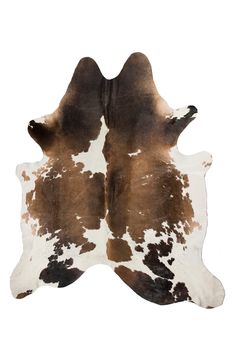 a brown and white cowhide rug is shown on a white background with black spots