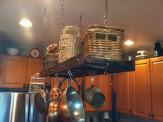 pots and pans hanging from the ceiling in a kitchen