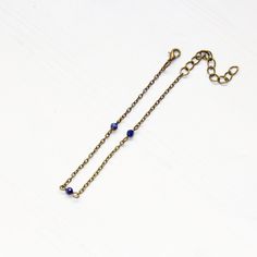 "This dainty gemstone anklet is perfect for the beach but is also delicate enough to wear with a fun dress. Day to night vibes! Lapis lazuli tiny gemstones Nickel-free brass chain - 7.5\" with 2\" extender Lapis lazuli enhances communication, intuition, psychic perceptions and channeling abilities. Used to promote a clear mind and to provide spiritual protection. It possesses enormous serenity and is the key to spiritual attainment and wisdom. Bringing qualities of honesty, compassion and uprigh Adjustable Beaded Chain Anklet As Gift, Adjustable Anklet With Lobster Clasp, Beaded Bracelet Anklet As Gift, Gemstone Anklet, Dainty Anklet, Beaded Anklet, Anklets Boho, Carnelian Necklace, Lapis Lazuli Beads