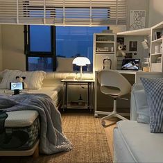 a bedroom with a bed, desk and computer