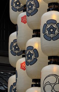 many white lanterns with blue and red designs on them