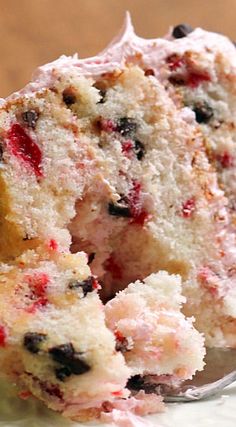 a close up of a piece of cake on a plate with a fork in it