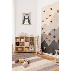 a child's playroom with climbing wall and stuffed animals on the rugs