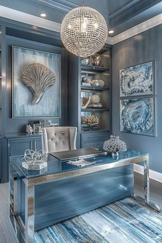 an elegant office with blue walls and silver furniture, chandelier hanging from the ceiling