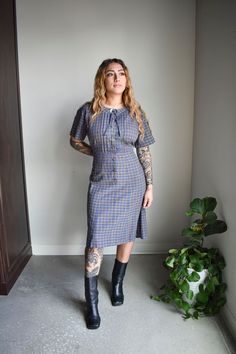 "ABOUT: Vintage 1950s/60s plaid cotton shirt dress with short sleeves and covered buttons at the center. This dress pulls over head and has a snap closure and decorative button with tie at the neckline.  It is unlined and in great condition for age, very classic. TAG: Caldwell Casuals TAG SIZE:  no size tag FITS LIKE: estimated at a modern small, please see measurements for details.  *NO REFUNDS IF ITEM DOES NOT FIT. IT IS BUYERS RESPONSIBILITY TO READ FULL MEASUREMENTS AND COMPARE TO A LIKE-GAR Retro Plaid Dress For Work, Vintage Plaid Short Sleeve Dress, Vintage Style Gingham Plaid Short Sleeve Dress, Vintage Gingham Plaid Dress With Short Sleeves, Vintage Gingham Plaid Knee-length Dress, Retro Short Sleeve Plaid Dress, Retro Plaid Dress For Daywear, Vintage Plaid Dress For Work, Fitted Plaid Dress With Buttons And Short Sleeves