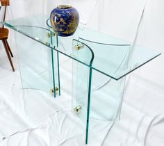 a glass table with a vase sitting on top of it