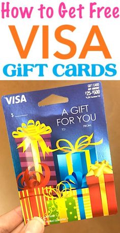 a person holding up a visa gift card