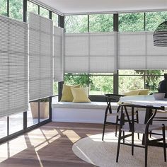 a dining room table and chairs with blinds on the windows