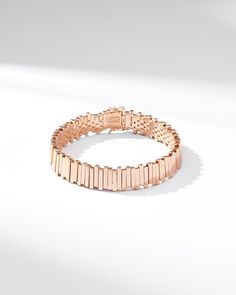 Embrace timeless elegance with our Golden Stacker Tennis Bracelet. Expertly crafted in 18-karat gold, this bracelet features pieces luminous baguette shaped gold pieces, set in a unique, modern uneven arrangement. Designed for ultimate comfort, it offers a smooth and flexible fit. Details 18k yellow gold, rose gold or white gold Bracelet measures 7" inches in length Box clasp with safety lock fastening 11mm width Ref: GCB119 Luxury Box Chain Bangle Jewelry, Luxury Bangle Bracelet With Solid Link Construction, Luxury Box Chain Bangle Bracelet, Luxury Rose Gold Diamond Bracelet With Baguette Diamonds, Elegant Rose Gold Bracelet With Solid Links, Luxury Rose Gold Chain Bracelet For Formal Occasions, Elegant Rose Gold Oyster Bracelet, Rose Gold Baguette Cut Tennis Bracelet For Formal Occasions, Luxury Rose Gold Bracelet With Rectangular Links