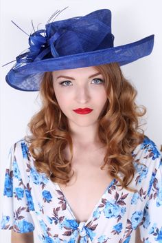 Soak up the sun in the chicest, vintage-styled sun hat. This hat has a slightly flipped brim silhouette, large mesh petals that make a statement not to be messed with and topped off with a delicate feather flower. This glam style features day-to-dark versatility for the perfect derby queen look! Evening Royal Blue Hat With Curved Brim, Evening Curved Brim Royal Blue Hat, Whimsical Blue Brimmed Hat, Elegant Blue Wide-brimmed Boater Hat, High Tea Hats, Whimsical Blue Wide-brim Hat, Royal Blue Fascinator, Kentucky Derby Style, Tea Hats