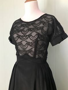 "* 1950s black cocktail dress * full pleated taffeta skirt * pointed inverted basque waist * sheer double layer lace bodice * short sleeves with taffeta cuffs and bows * scoop neck * low v-back * back metal zipper with series of hooks and eyes ✂ Measurements Bust: 36\"-37\" (dolman sleeves) Waist: 23\"-23.5\" (maybe a very snug 24\") Hips: free Shoulder to waist: 15\" Waist to hem: 26.5\" Length: 41.5\" Fits like: extra small Condition: Good. Some small breaks in the lace on the bodice - these w Evening Dress With Accordion Pleats And Full Skirt, 1950s Style Fit And Flare Party Dress, Accordion Pleated Full Skirt Party Dress, Full Skirt Dress With Accordion Pleats For Party, Vintage Pleated Party Dresses, 1950s Style Black Cocktail Dress, Black 1950s Style Cocktail Dress, Vintage Style Black Party Dress, Fitted Black Vintage 1950s Style Dress