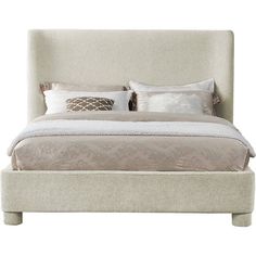 a bed with two pillows on top of it and a night stand next to it