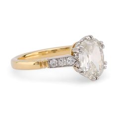 an oval cut diamond ring set in yellow gold