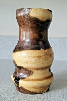 a wooden vase sitting on top of a table