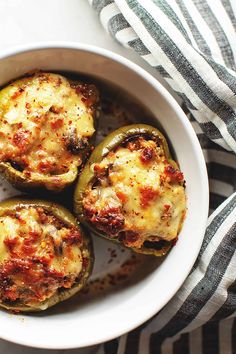 some stuffed peppers in a white bowl on a table