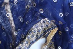 This gorgeous Navy Blue Net dupatta is so versatile and can be worn as a dupatta, scarf or on any wedding function. Our dupattas are handcrafted to perfection keeping in mind the authenticity of the culture in an urban way. Stand out with this intricately designed dupatta with Gold lace borders. ALL SALES ARE FINAL!! Blue Bohemian Anarkali Set With Pallu, Bohemian Blue Anarkali Set With Pallu, Bohemian Blue Choli With Cutdana, Blue Bohemian Anarkali Set For Wedding, Blue Bohemian Salwar Kameez With Traditional Drape, Blue Dupatta With Mirror Work In Traditional Drape, Blue Party Dupatta With Gota Work, Party Blue Dupatta With Gota Work, Bohemian Blue Anarkali Set For Festive Occasions