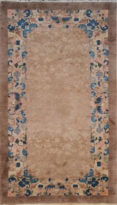 an old rug with blue and beige designs on it's border, in front of a white background