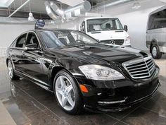 a black mercedes s - class parked in a garage