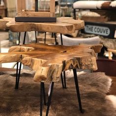 the table is made out of wood and has metal legs on each side, along with a wooden chair