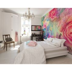 a bed room with a neatly made bed and a chandelier