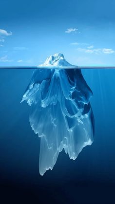 an iceberg floating in the middle of the ocean