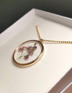 A beautiful and unique Botanical inspired terrarium necklace with a real delicate gypsophila flower. Gypsophila flowers are a symbol of purity. The flower is encapsulated in a crystal clear Resin which is Non-toxic, No VOCs, No fumes, No solvents, Non-flammable, Non-hazardous, No BPA. The metals used are all nickel free.  The necklace chain is gold plated. The pendant is 1 inch in width and length. A choice of chains: gold plated solid brass chainDelicate gold filled cable chain ready made neckl Delicate Rose Gold Keepsake Jewelry, Delicate Gold Plated Birth Flower Jewelry, Gold Charm Necklace With Pressed Flowers In Round Pendant, Delicate Rose Gold Birth Flower Charm Necklace, Dainty Gold Jewelry With Pressed Flowers, Delicate Gold Necklace With Pressed Flowers, Delicate Rose Gold Necklace With Pressed Flowers, Dainty 14k Gold Filled Birth Flower Necklace, Delicate Pressed Flowers Necklace Keepsake